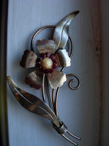 I've looked at the blurry image of Jean's brooch on her blouse long enough that I'm fairly certain it's a flower (though witch on a broomstick was a close second) - search eBay for "1940 flower brooch" and the options are plentiful!