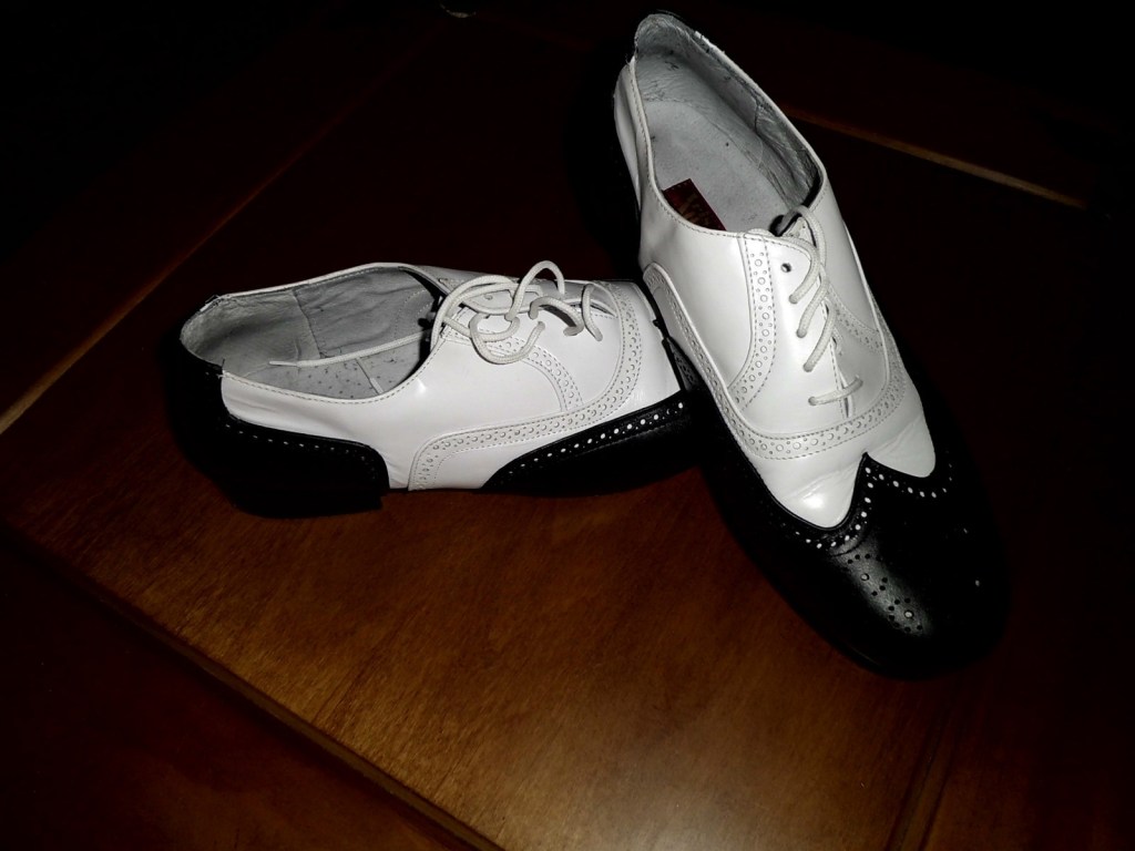 Black and white wingtip oxfords, size 10, starting bid $29