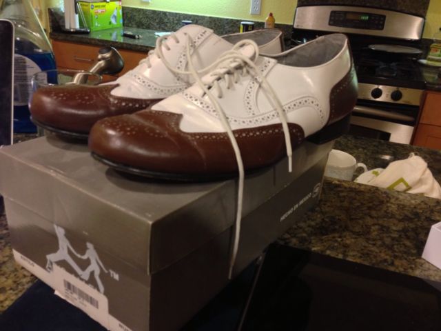 Brown and white wingtip oxfords, size 10.5, starting bid $40
