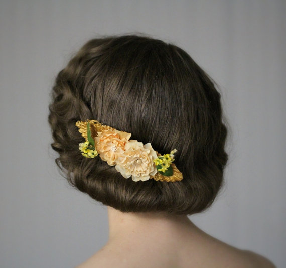 Marigolds, tiny yellow flowers, and straw on a hair comb